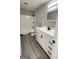 A bathroom featuring a white vanity with matte black hardware and a shower-tub combination at 95 Grove Creek Dr, Locust Grove, GA 30248
