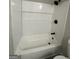 Bathroom showcasing a combined tub-shower featuring white subway tile and a toiletry shelf at 95 Grove Creek Dr, Locust Grove, GA 30248