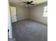 Neutral bedroom with new carpet, a window, and a modern ceiling fan at 95 Grove Creek Dr, Locust Grove, GA 30248