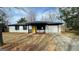 Charming ranch-style house with a bright yellow front door and an attached one-car garage at 95 Grove Creek Dr, Locust Grove, GA 30248