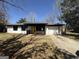 Charming ranch-style house with a bright yellow front door and an attached one-car garage at 95 Grove Creek Dr, Locust Grove, GA 30248