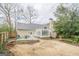 Spacious backyard with patio, outdoor seating, and mature trees perfect for outdoor activities at 6360 Brookline Ct, Cumming, GA 30040