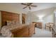 Bedroom featuring carpet, a wooden ceiling fan, and closet access at 6360 Brookline Ct, Cumming, GA 30040