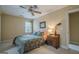 Cozy bedroom featuring carpet, a ceiling fan, and window views at 6360 Brookline Ct, Cumming, GA 30040