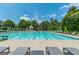 Stunning pool with lane lines and sun loungers, set against a backdrop of lush greenery, for leisurely swims and relaxation at 6360 Brookline Ct, Cumming, GA 30040