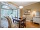 Inviting dining area connected to a sunroom with large windows, offering plenty of natural light at 6360 Brookline Ct, Cumming, GA 30040