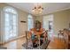 Traditional dining room with wooden table set, chandelier, and large windows with natural light at 6360 Brookline Ct, Cumming, GA 30040