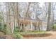 Charming two-story home featuring a covered front porch, dormer windows, and a well-maintained front yard at 6360 Brookline Ct, Cumming, GA 30040