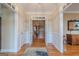 Inviting foyer featuring hardwood floors, decorative wallpaper and views into other rooms of the home at 6360 Brookline Ct, Cumming, GA 30040
