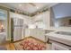 Bright kitchen features white cabinetry, stainless steel appliances, and lots of natural light at 6360 Brookline Ct, Cumming, GA 30040