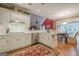 Spacious kitchen features stainless steel appliances, white cabinetry and breakfast bar at 6360 Brookline Ct, Cumming, GA 30040
