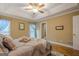 Relaxing main bedroom featuring hardwood floors, tray ceilings and natural light at 6360 Brookline Ct, Cumming, GA 30040