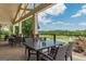 Charming covered patio featuring outdoor seating, ideal for enjoying the views of the pond and golf course at 6360 Brookline Ct, Cumming, GA 30040