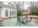 Back patio with outdoor table and chairs, ideal for entertaining or relaxing in the backyard at 6360 Brookline Ct, Cumming, GA 30040
