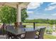Relaxing patio seating area with picturesque views of the lush golf course and pond, perfect for outdoor enjoyment at 6360 Brookline Ct, Cumming, GA 30040