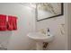 Charming powder room with pedestal sink, decorative mirror, and stylish fixtures at 6360 Brookline Ct, Cumming, GA 30040