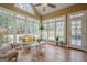 Bright sunroom with tile floors, multiple windows, and cozy wicker furniture at 6360 Brookline Ct, Cumming, GA 30040