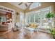 Bright sunroom featuring wicker furniture, tile floor, and large windows offering beautiful outdoor views at 6360 Brookline Ct, Cumming, GA 30040