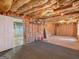View of unfinished basement with insulation, door, and some flooring at 150 Grove Creek Dr, Locust Grove, GA 30248