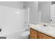 Clean, bright bathroom with white tub/shower combo and oak vanity with modern sink at 150 Grove Creek Dr, Locust Grove, GA 30248