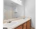 Bathroom featuring a double sink vanity with oak cabinets and a large mirror at 150 Grove Creek Dr, Locust Grove, GA 30248