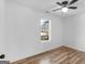 Simple bedroom with wood-look floors and large window offering natural light at 150 Grove Creek Dr, Locust Grove, GA 30248