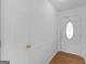 Bright entryway with hardwood flooring and a decorative glass front door at 150 Grove Creek Dr, Locust Grove, GA 30248