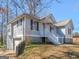 Charming exterior view of home with attached garage and white porch at 150 Grove Creek Dr, Locust Grove, GA 30248