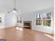 Bright living room featuring hardwood floors, fireplace, and an open layout at 150 Grove Creek Dr, Locust Grove, GA 30248