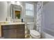 Bathroom with vanity, a window, and a shower with a marble-patterned shower curtain at 317 Lucan Way, Riverdale, GA 30274