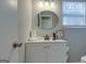 Bathroom features vanity with sink, mirror, and cabinet storage at 317 Lucan Way, Riverdale, GA 30274