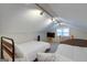 Bright bedroom featuring two beds, sloped ceilings, and natural light from a window at 317 Lucan Way, Riverdale, GA 30274