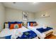 Bedroom featuring twin beds with vibrant bedding and decorative artwork at 317 Lucan Way, Riverdale, GA 30274