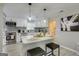Renovated kitchen with white cabinets, gray backsplash, stainless steel appliances, and breakfast bar at 317 Lucan Way, Riverdale, GA 30274