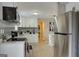 Bright kitchen features stainless steel appliances, white cabinets, and light gray backsplash at 317 Lucan Way, Riverdale, GA 30274