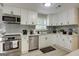 Modern kitchen featuring white cabinetry, stainless steel appliances, and gray subway tile backsplash at 317 Lucan Way, Riverdale, GA 30274