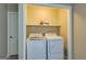 Laundry room features a washer, dryer, and overhead shelving at 317 Lucan Way, Riverdale, GA 30274