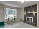 Bright living room with stone fireplace, large window, and modern decor at 317 Lucan Way, Riverdale, GA 30274
