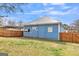Rear exterior view of home showing fenced yard and carport at 1616 Park Ne St, Conyers, GA 30012
