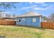 Side exterior view of blue home featuring a privacy fence at 1616 Park Ne St, Conyers, GA 30012