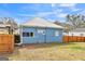Side exterior view of blue home featuring a privacy fence at 1616 Park Ne St, Conyers, GA 30012