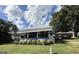 Charming blue home featuring a quaint front porch, a metal roof, and a well-maintained lawn at 1616 Park Ne St, Conyers, GA 30012