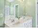 Bright bathroom with dual vanity sinks, large mirror and natural light at 3867 Summer Kitchen Way, Lilburn, GA 30047