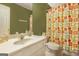 Bathroom featuring a white vanity and a vibrant shower curtain with geometric shapes at 3867 Summer Kitchen Way, Lilburn, GA 30047