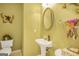 Charming half bathroom with pedestal sink and decorative accents at 3867 Summer Kitchen Way, Lilburn, GA 30047
