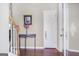 Elegant entryway featuring hardwood floors, table with flower vase, and white interior door at 3867 Summer Kitchen Way, Lilburn, GA 30047