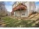 Rear exterior view featuring a spacious deck and access to the backyard and basement at 3867 Summer Kitchen Way, Lilburn, GA 30047