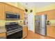 Modern kitchen with stainless steel appliances, granite countertops, and ample storage space at 3867 Summer Kitchen Way, Lilburn, GA 30047