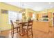 Kitchen and dining nook with wood floors, light cabinets, and natural light at 3867 Summer Kitchen Way, Lilburn, GA 30047