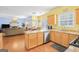 Open-concept kitchen with island, stainless steel appliances, and seamless flow to living area at 3867 Summer Kitchen Way, Lilburn, GA 30047